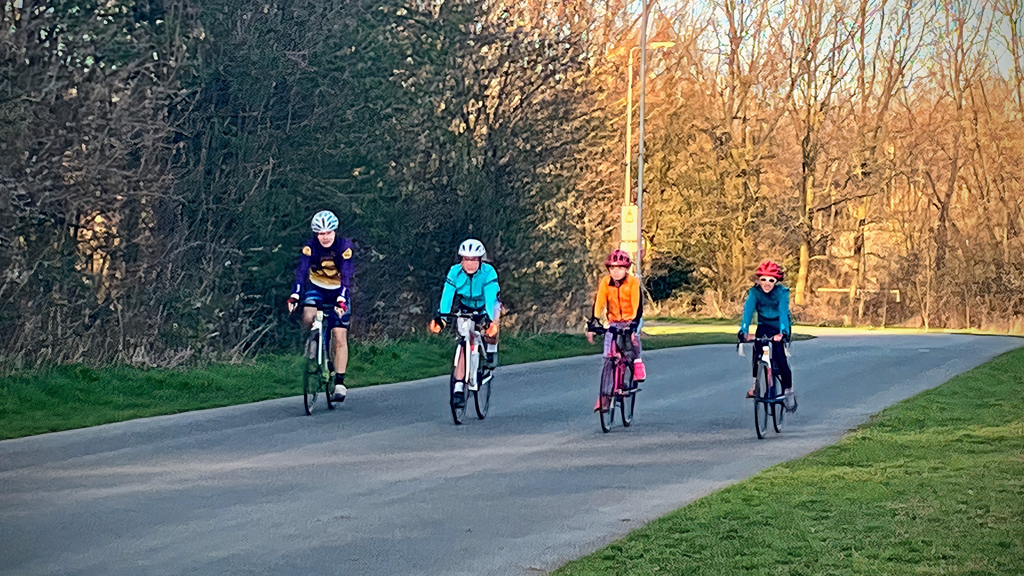 Four young ladies cycling together in support of each other.